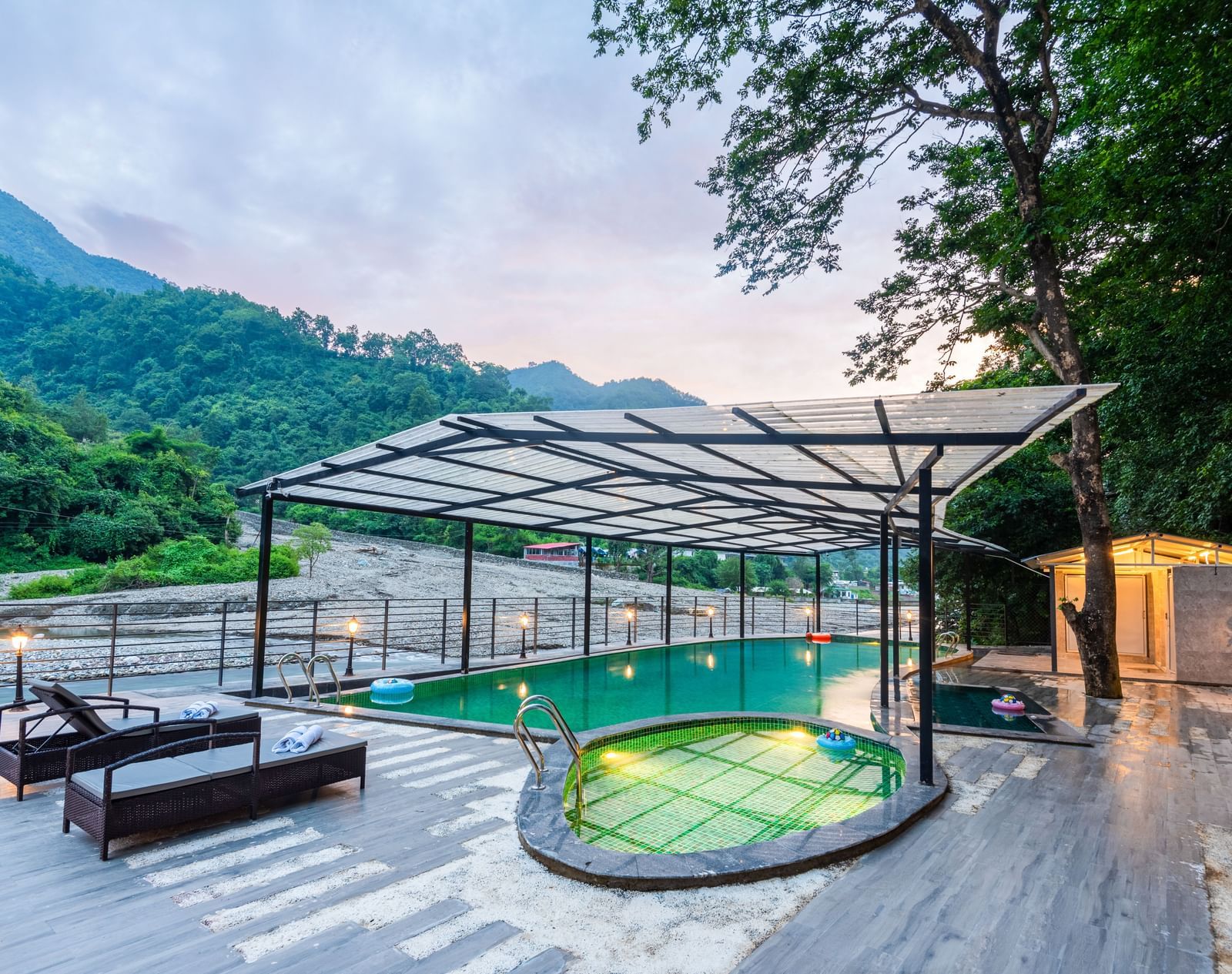 A swimming pool at DLS Divine River Resort and Spa with panoramic views and lounge chairs 